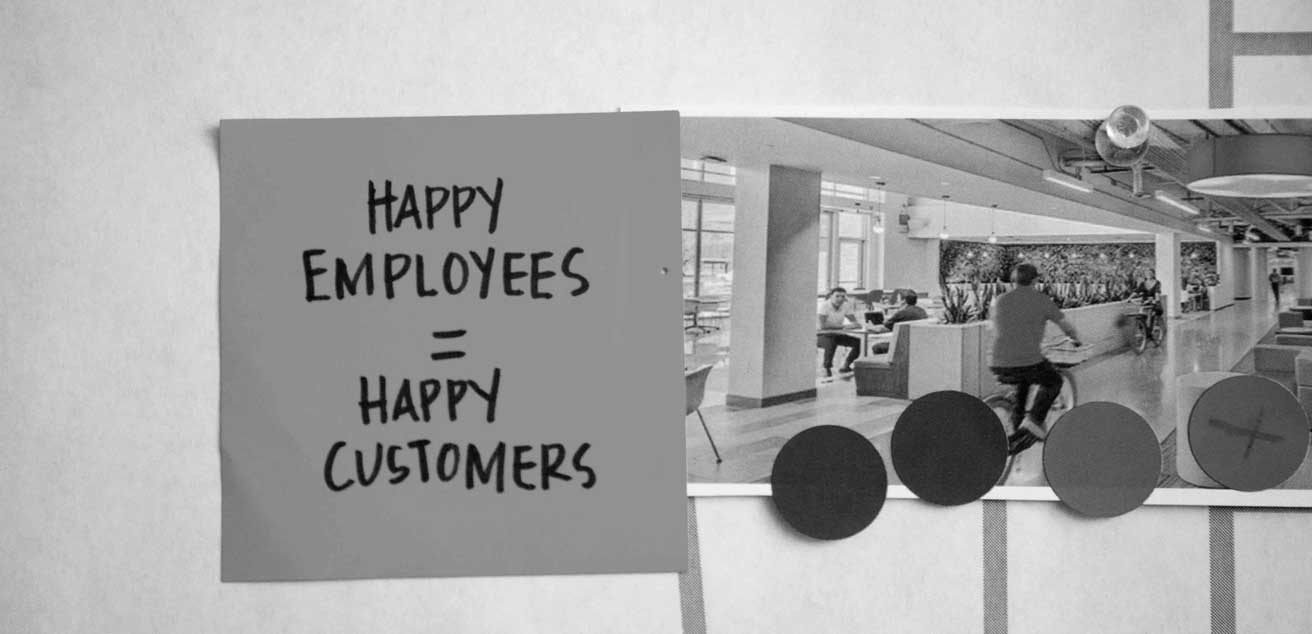 Post-it note that reads "Happy Employees = Happy Customers"