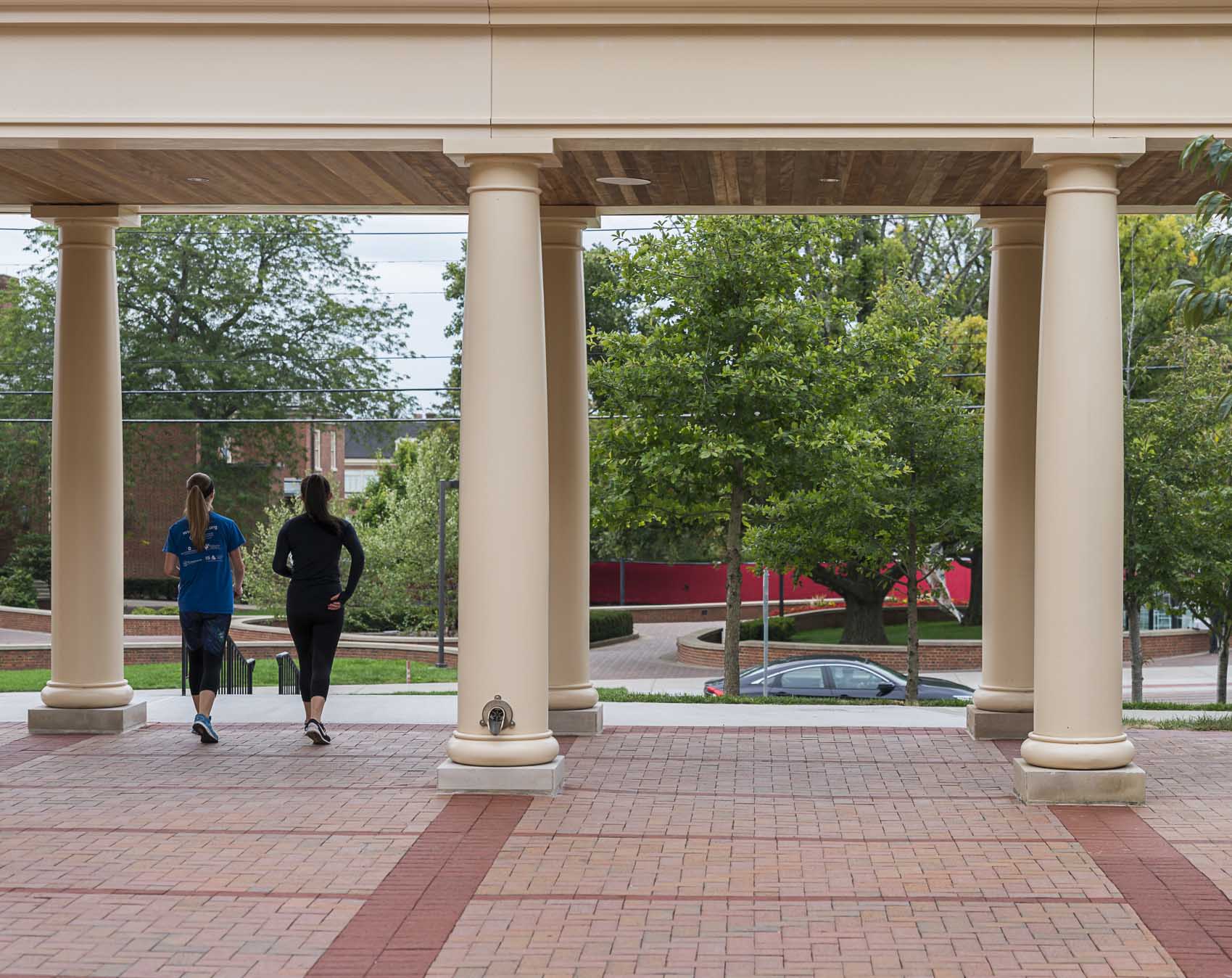 Two students walking under awning at Miami University