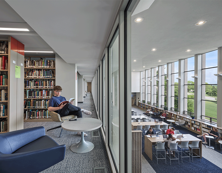 Users enjoying the Alter Library at Mount St. Joseph University, with large windows flooding the space with natural light.