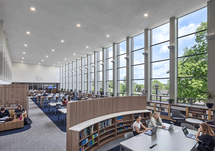 Users enjoying the Alter Library at Mount St. Joseph University, with large windows flooding the space with natural light.