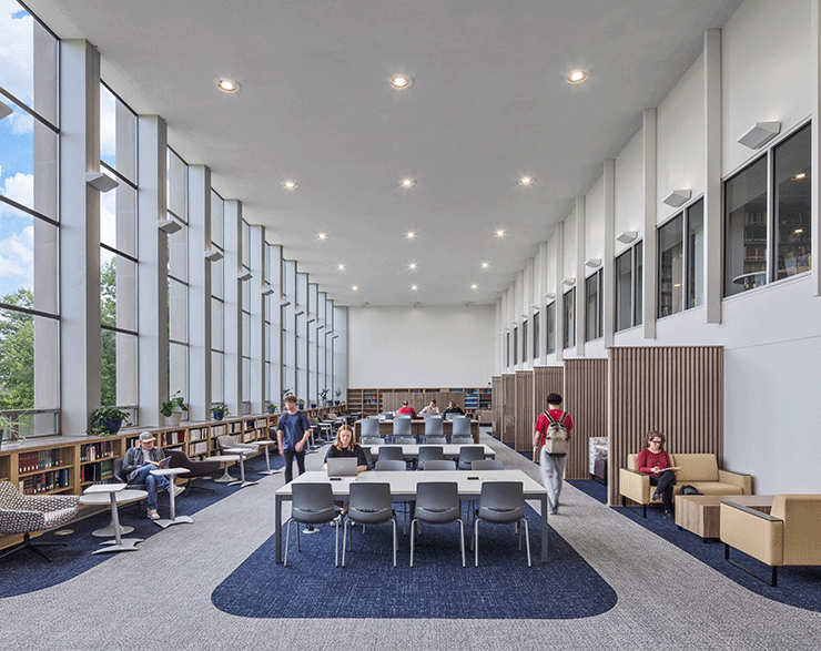 Users enjoying the Alter Library at Mount St. Joseph University, with large windows flooding the space with natural light.