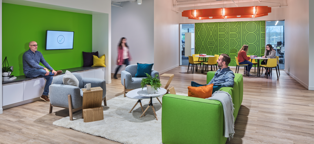 People socializing in the breakroom at Quantum Health 