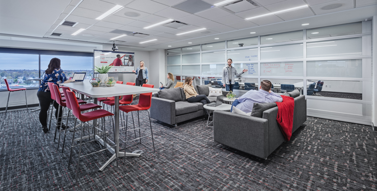 Employees collaborating in a flexible environment with comfortable and adjustable seating