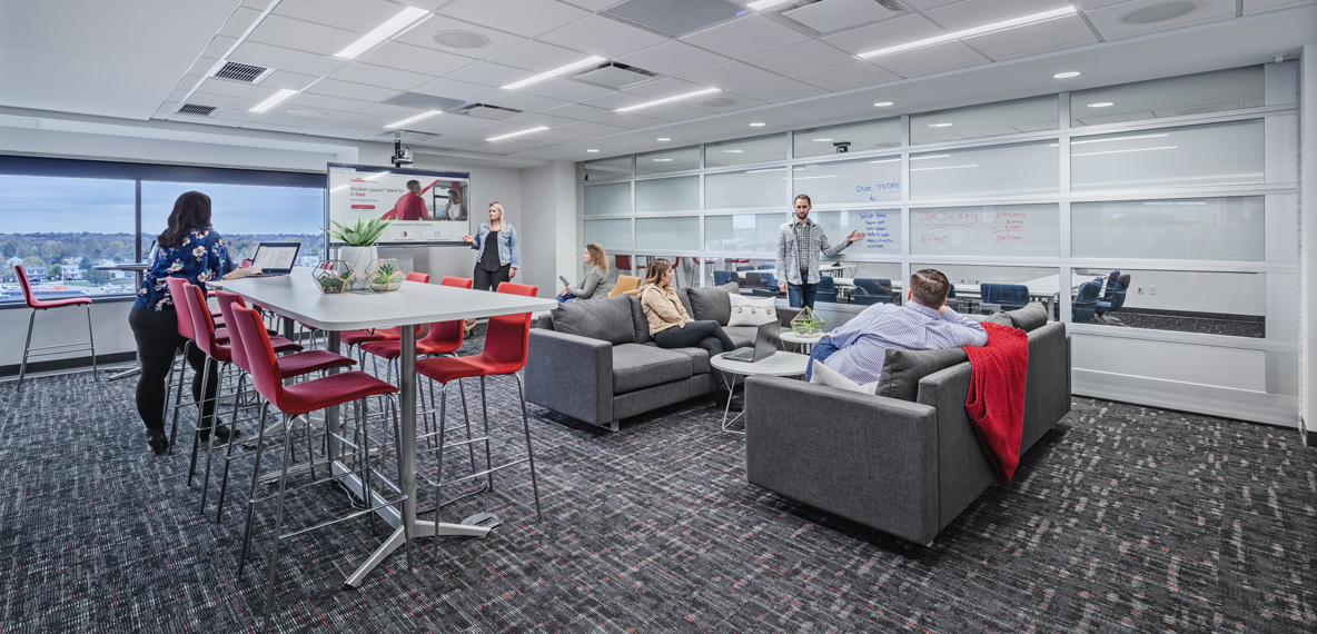 Employees collaborating in a flexible environment with comfortable and adjustable seating