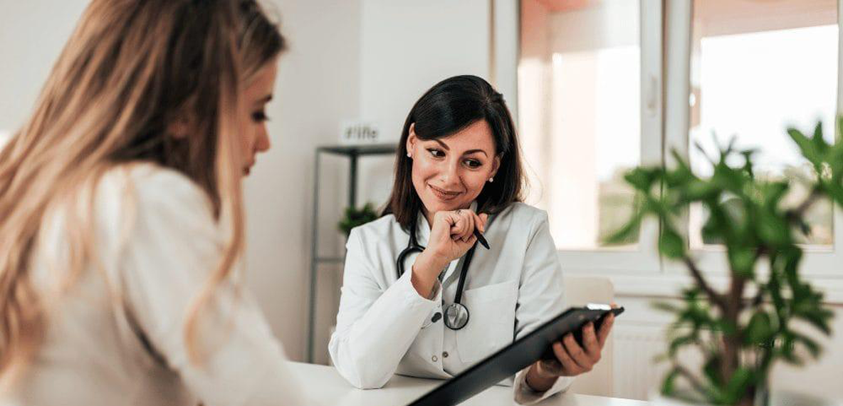 Two women, one doctor and a patient, discussing medical results 