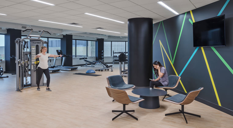 Two women working out in the gym at Group RMC's Hub 65