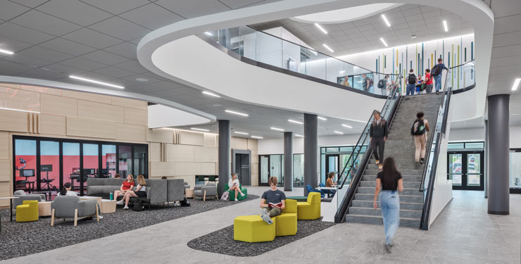 Student utilizing the lobby of Miami University's McVey Data Science Building