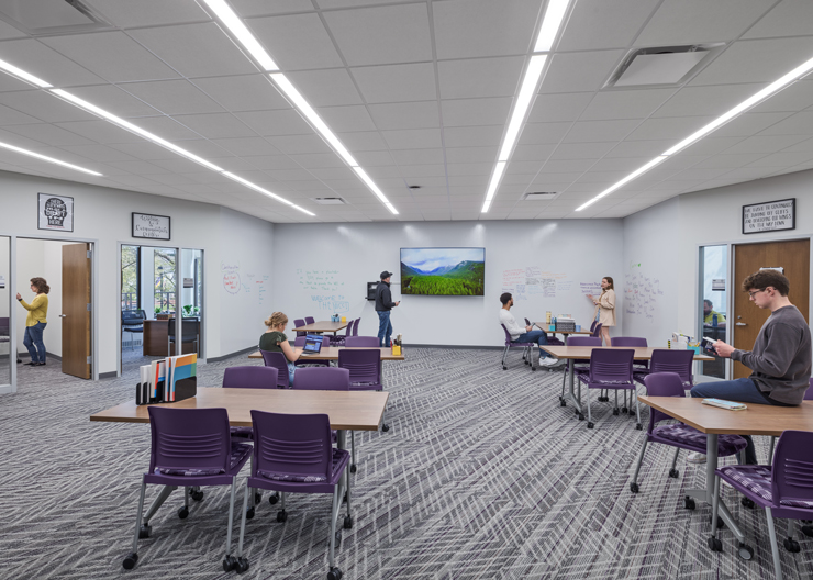 Students work solo or study in groups inside a multi-purpose room