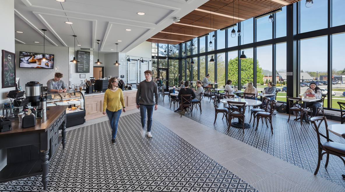 Students walk through the new cafe that was added onto the library