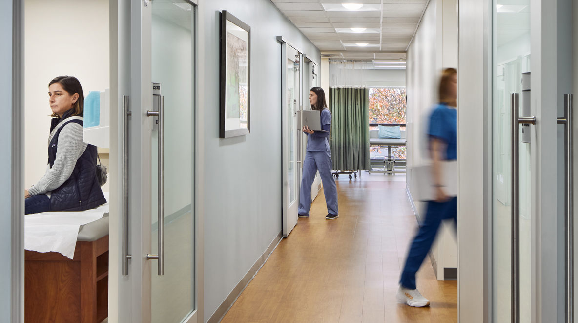 A hallway with multiple exam rooms is shown, all with sliding doors