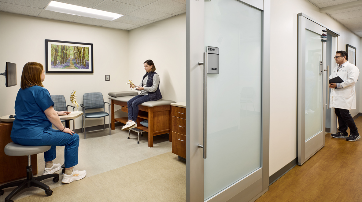 A patient talks with their provider in an exam room