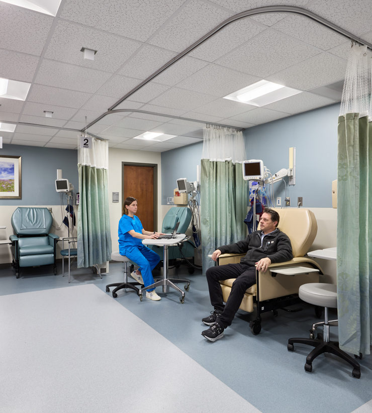 A patient and provider sit in the pain management clinic