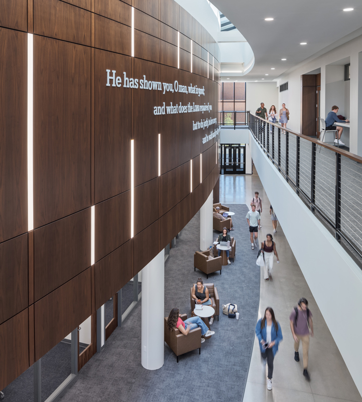 Students walk through an atrium 