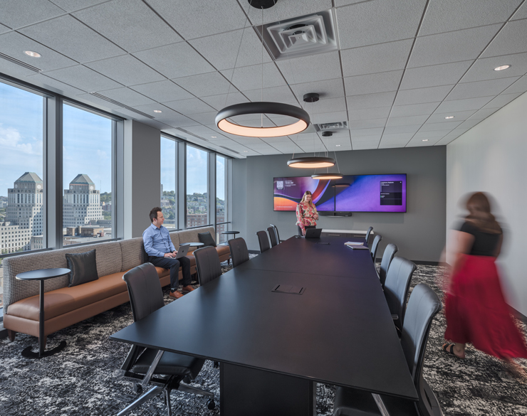 Employees gather in a board room