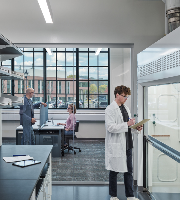 A glimpse into a research lab that is backed by a large transparent glass panel