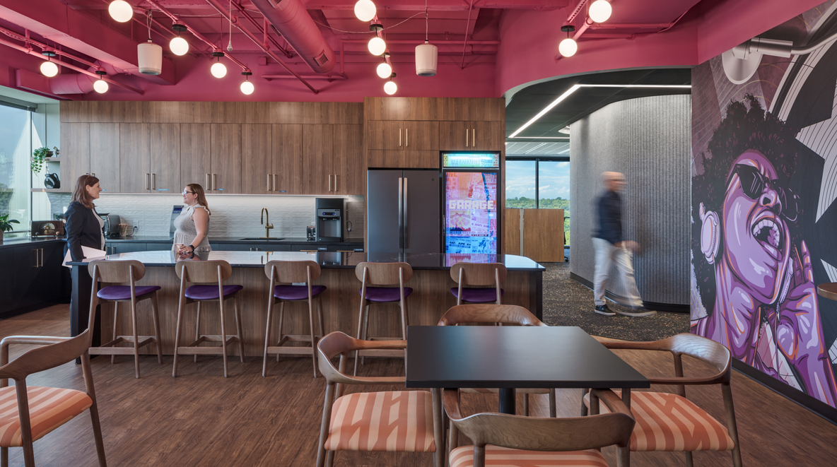 Employees chat in the kitchen/break area