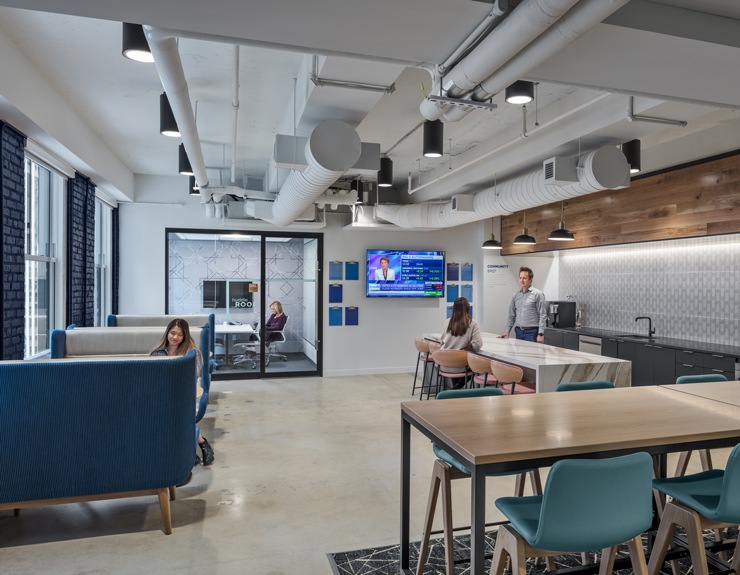 Kitchen area in their new office with a community corner