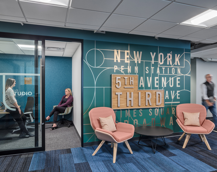 The entrance of a small conference room is marked by a large feature showcasing some popular streets in the city