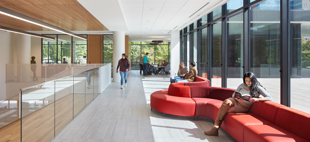 Natural light flows into UC's new law building through large windows that also showcase greenery outside