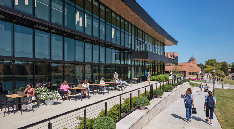 Students occupy a veranda facing Cedar Lake