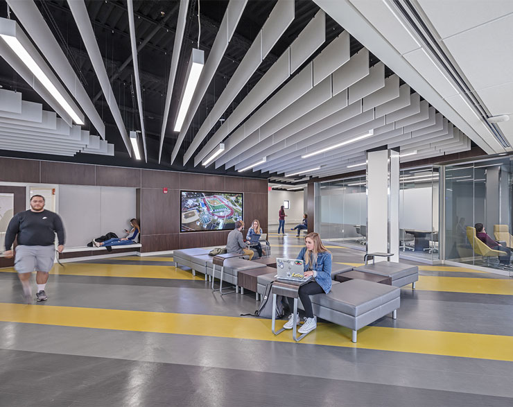 Students take advantage of the open work area with different nooks and huddle rooms