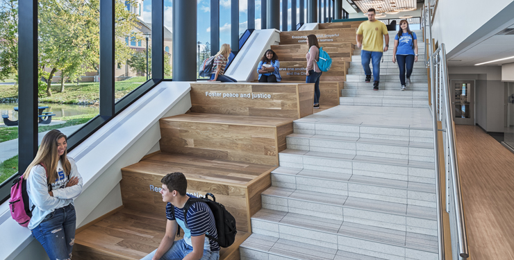 Students gather on a staircase inside University of St. Francis Achatz Hall