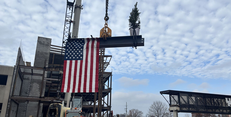 A beam is lifted up during the topping out ceremony